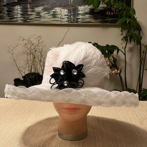 Elegant White Feathered Hat with Black Floral Accent